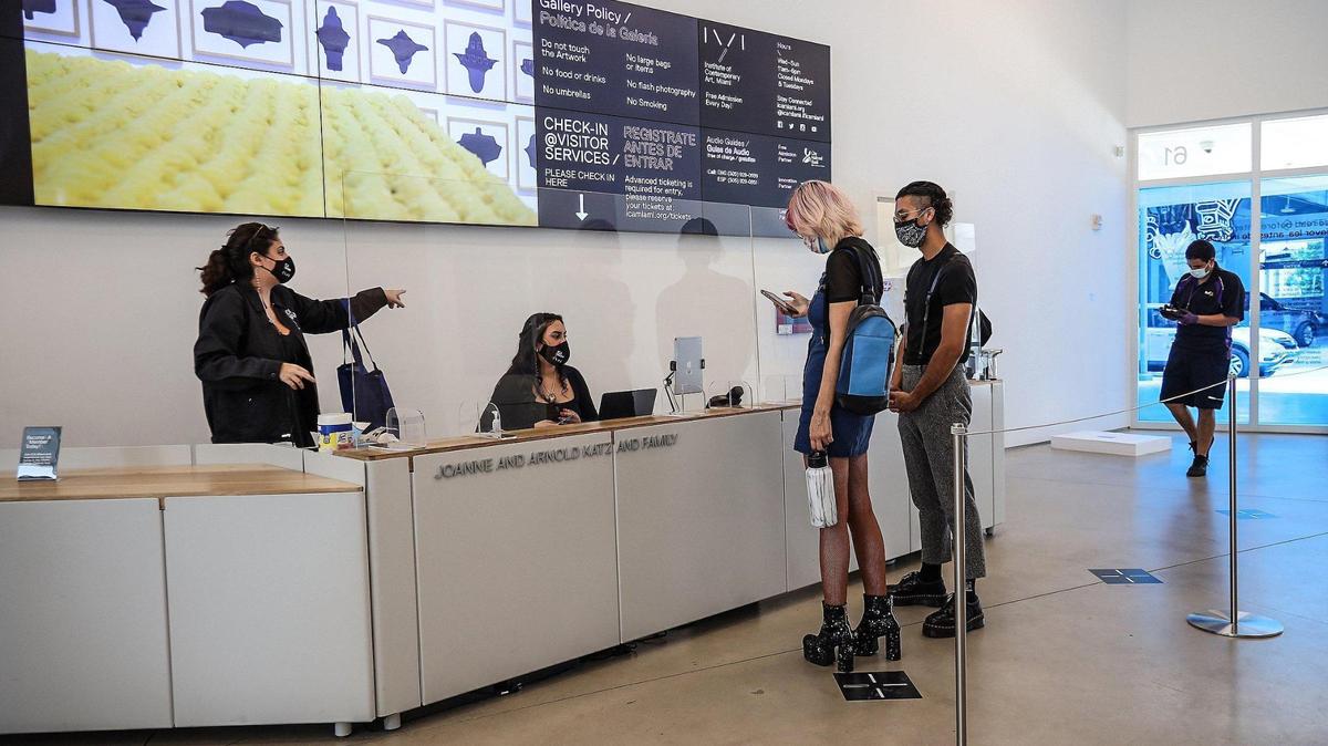 From behind a plexiglass shield, staff members at the Institute of Contemporary Art, Miami, greet some of its first visitors — Vincent Electra, 23, and boyfriend Doug Giraldo, 25 — during the museum’s reopening Sept. 2 under strict safety protocols. It was the first art museum in Miami-Dade to reopen since the COVID-19 pandemic forced closure of the county’s cultural institutions.