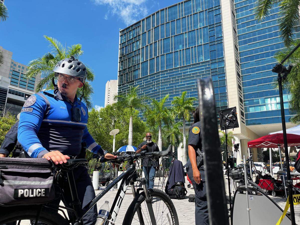 A City of Miami police officer helps clear the area in front of the federal courthouse while Miami police help Federal Protective Services check out a “suspicious object.”