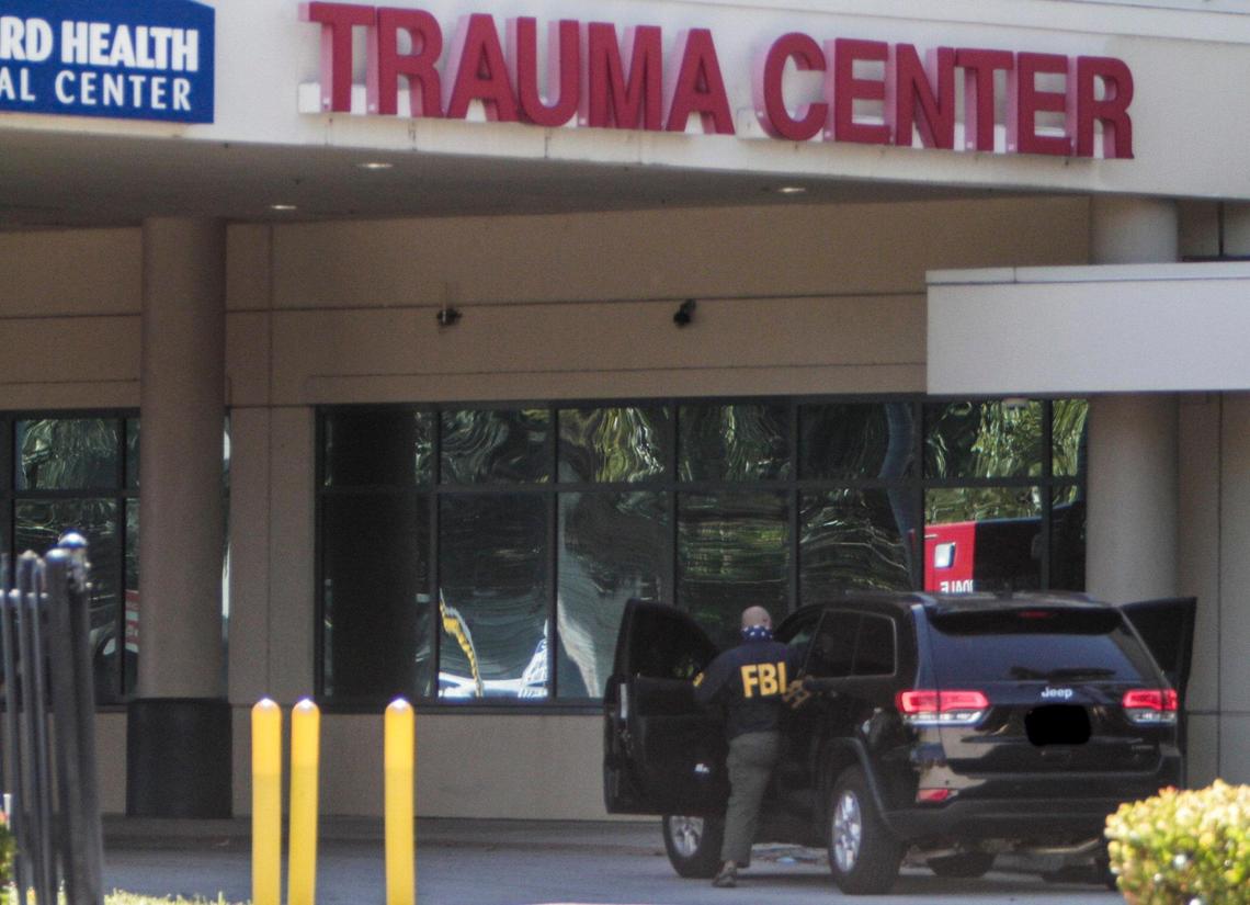 FBI agents get in their vehicle parked at the emergency entrance of Broward Health Medical Center in Fort Lauderdale on Tuesday.