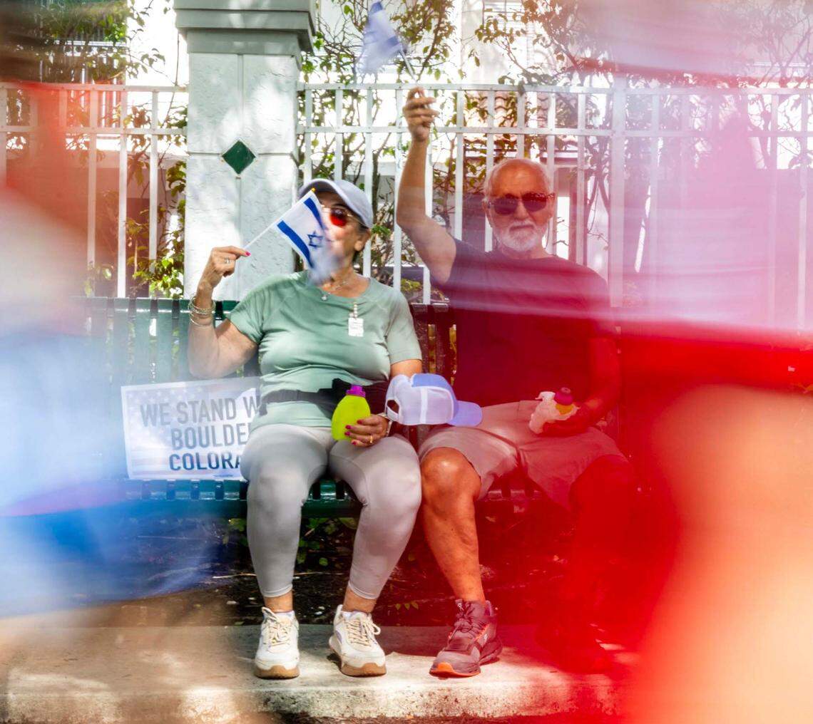Malka Aarno, 78, and her husband Jacob, 90, wave Israeli flags as they take a break from walking during a solidarity “Run for Their Lives” walk to raise awareness for the 58 hostages still held in Gaza at Aventura Circle on Sunday, June 8, 2025, in Aventura, Fla.