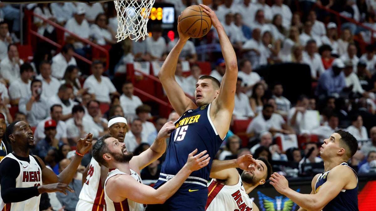 Miami Heat forward Kevin Love (42) and Miami Heat guard Max Strus (31) defend against Denver Nuggets center Nikola Jokic (15) in the first half of Game 4 of the NBA Finals at the Kaseya Center in downtown Miami, Fla. on Friday, June 9, 2023.