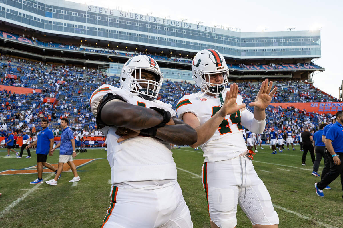 Aug 31, 2024; Gainesville, Florida, USA; Miami Hurricanes defensive lineman Armondo Blount (18) and Miami Hurricanes defensive lineman Cole McConathy II (44) celebrate against the Florida Gators after the game at Ben Hill Griffin Stadium. Mandatory Credit: Matt Pendleton-USA TODAY Sports
