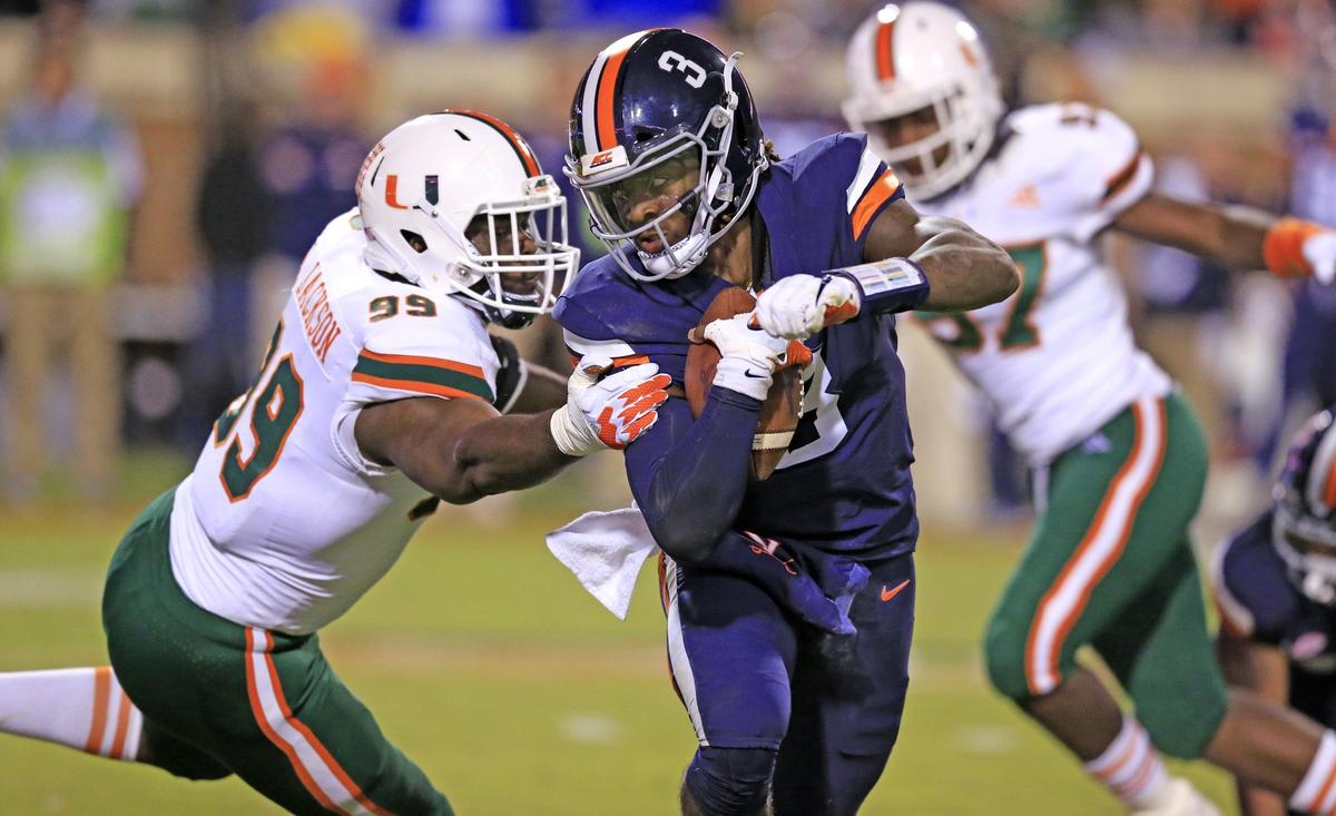 Miami Hurricanes defensive lineman Joe Jackson (99) chases Virginia Cavaliers quarterback Bryce Perkins (3) in the second quarter as the University of Miami Hurricanes visit the Virginia Cavaliers at Scott Stadium in Charlottesville, VA on Saturday, October 13, 2018.