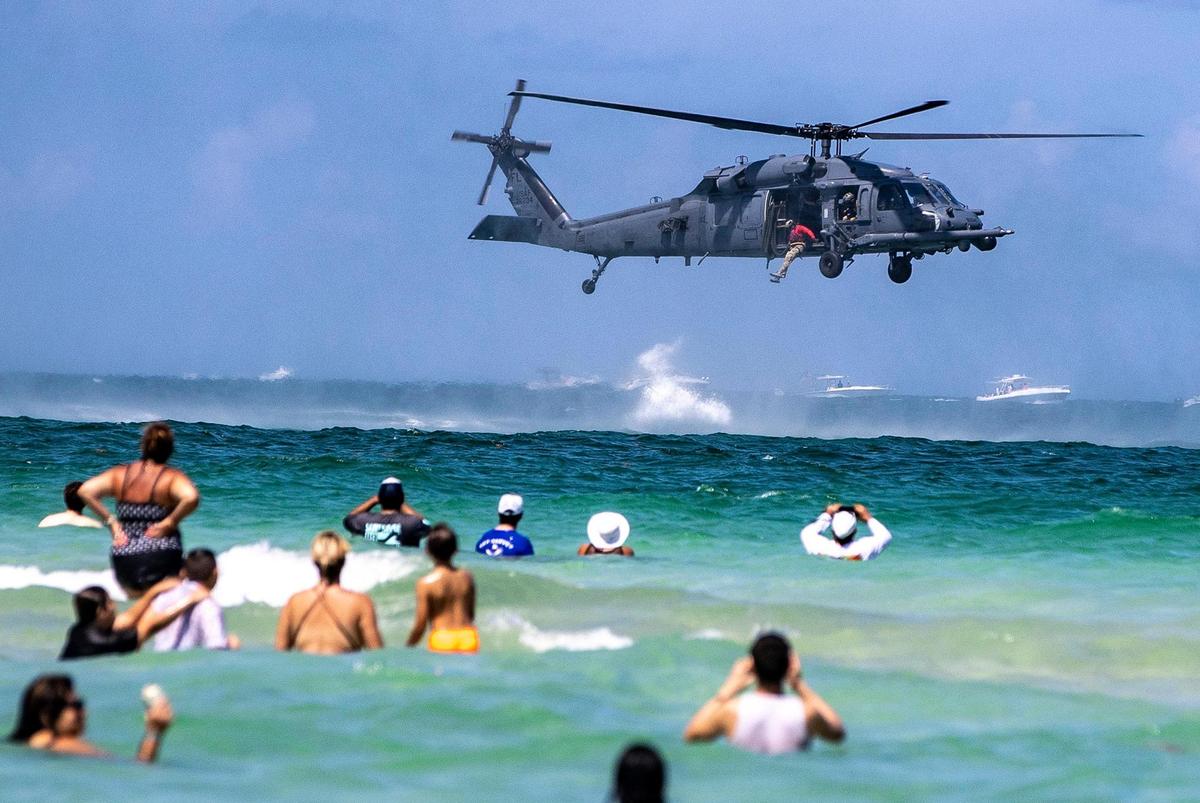 Beach goers watch as members of the USAF 920th Combat Search & Rescue Demo perform a rescue exercise during the Hyundai Air & Sea Show 2022 in Miami Beach. on Saturday May 28, 2022,