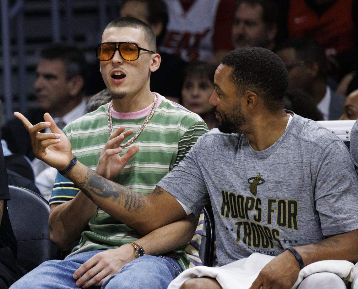 Miami Heat guard Tyler Herro (14) talks to Miami Heat guard Norman Powell (24) while on the bench during the first half of a game against the Cleveland Cavaliers on Nov. 10, 2025, at Kaseya Center in Miami.