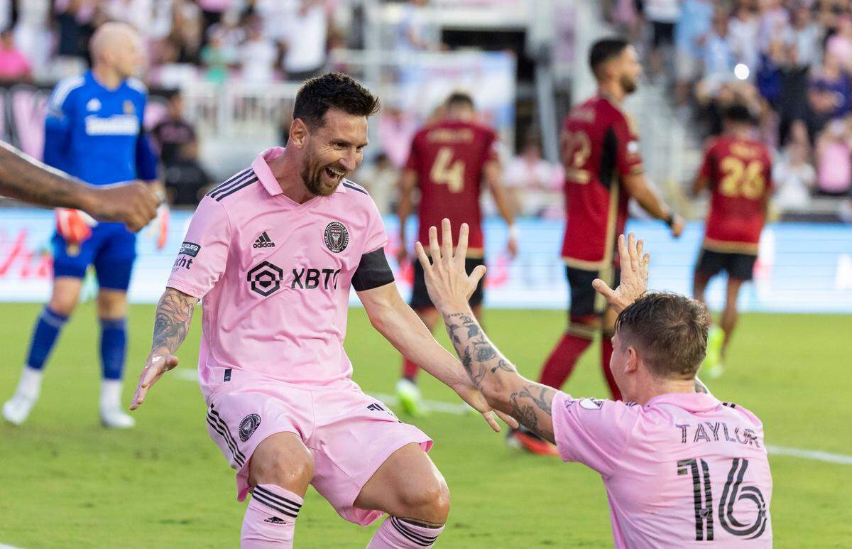 Inter Miami forward Lionel Messi (10) celebrates with Robert Taylor (16) after scoring a second goal against Atlanta United in the first half of their Leagues Cup group stage match at DRV PNK Stadium on Tuesday, July 25, 2023, in Fort Lauderdale, Fla.