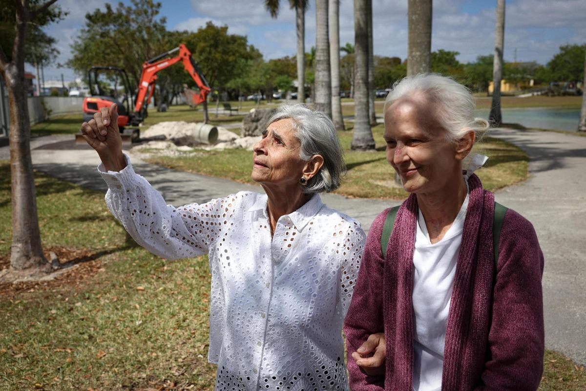 Silvia Unzueta, left, a Women’s Park founder, and Bonnie Bolton, whose mother Roxcy was also a founder, pose in front of the time capsule that the founders buried 31 years ago during an unveiling ceremony on Wednesday, March 22, 2023, at Women’s Park in Miami. The time capsule was buried in 1992 and was supposed to be dug up on the 100th anniversary of women’s suffrage but got delayed due to COVID-19.