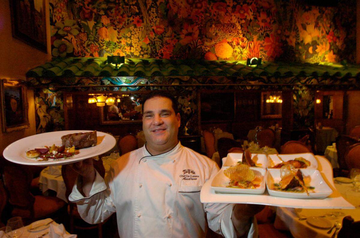 In 2006, Chef Andrew Swersky of the Forge at 432 41st St. holds up bone-in filet mignon, baby root vegetable salad with gorganzola, spiced pecans, and seared tuna, scallop lobster claw and salmon four ways.