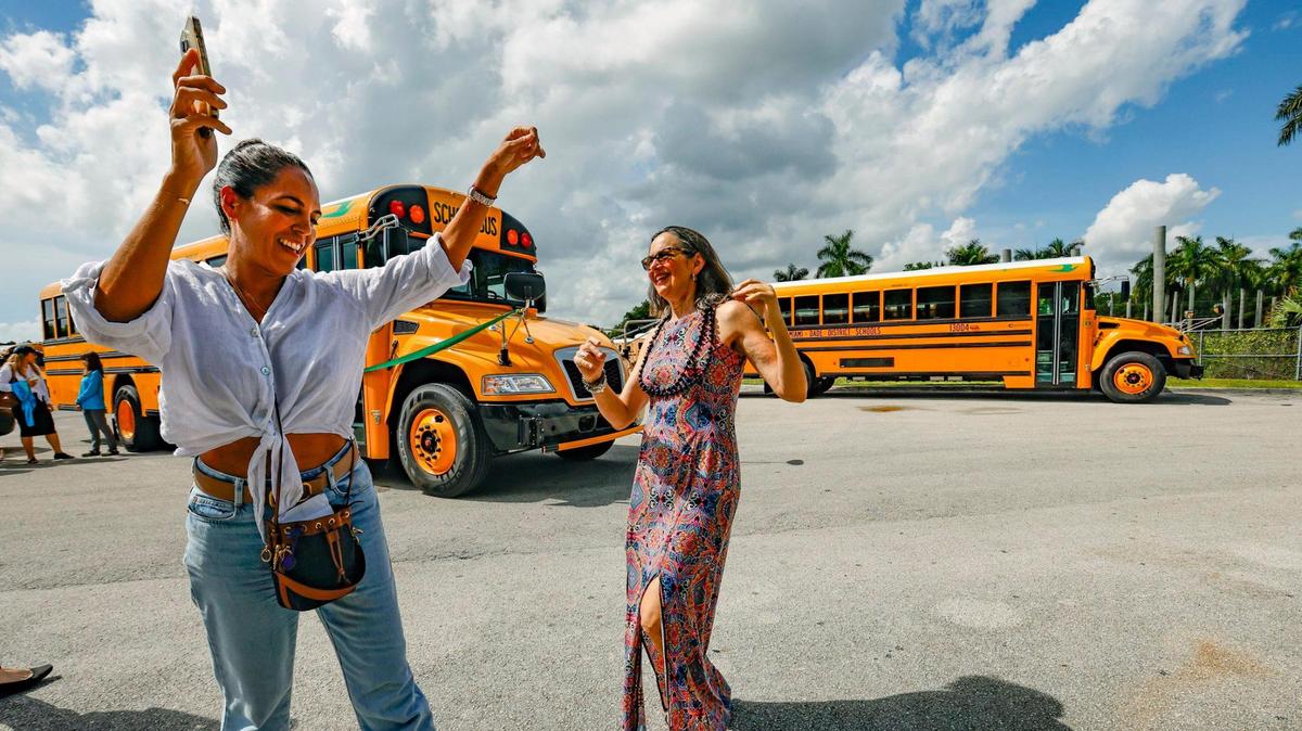 Suzette Siblesz and Helena Paisley, left to right, dance to ‘Electric Boogie’ as Miami-Dade County Public Schools unveil 20 new electric buses as part of its fleet of nearly 1,000 vehicles in Miami on Tuesday, Aug. 15, 2023. Last year, the Florida Department of Environmental Protection awarded more than $57 million to 13 counties to purchase electric school buses through the state’s Volkswagen Mitigation Settlement Trust Fund.