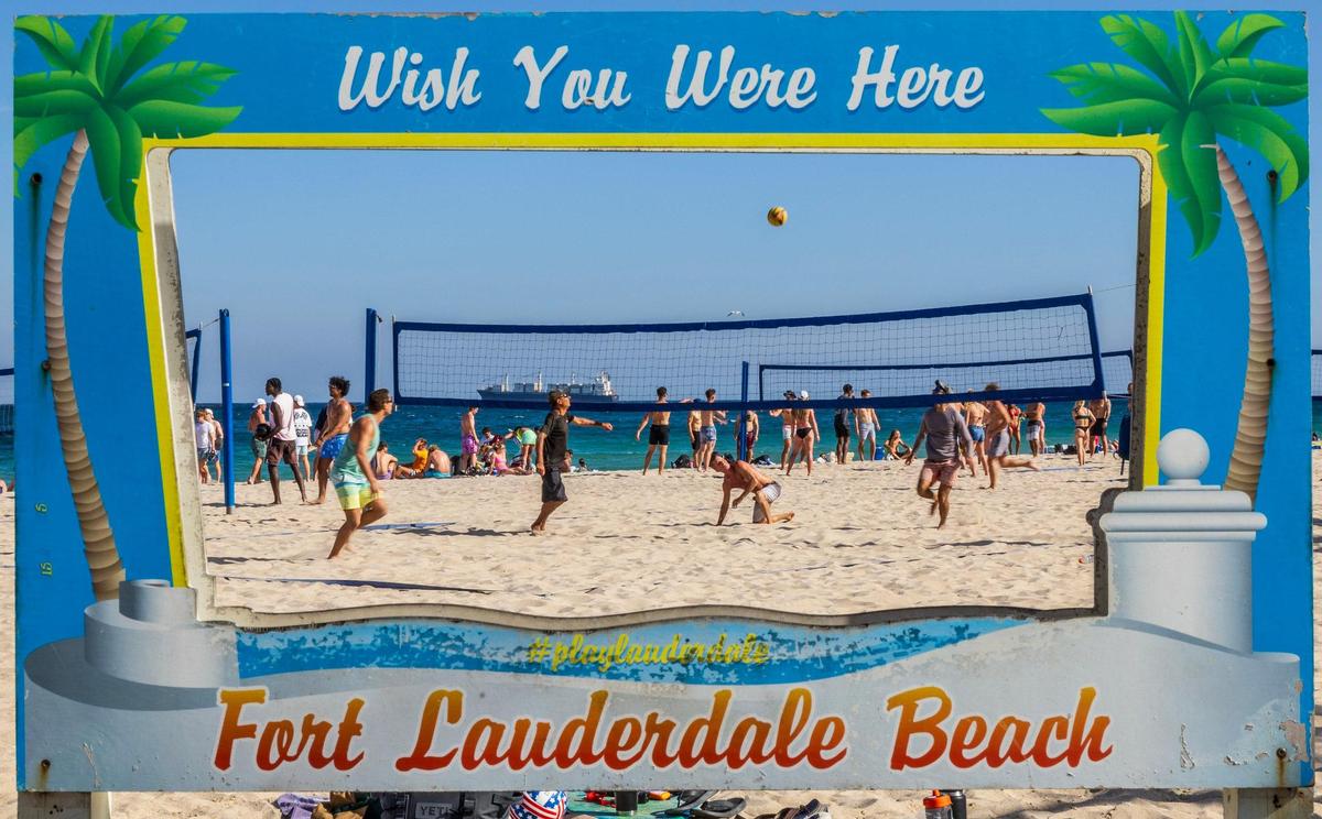 Spring breakers enjoy the nice weather playing beach volleyball at Fort Lauderdale Beach.