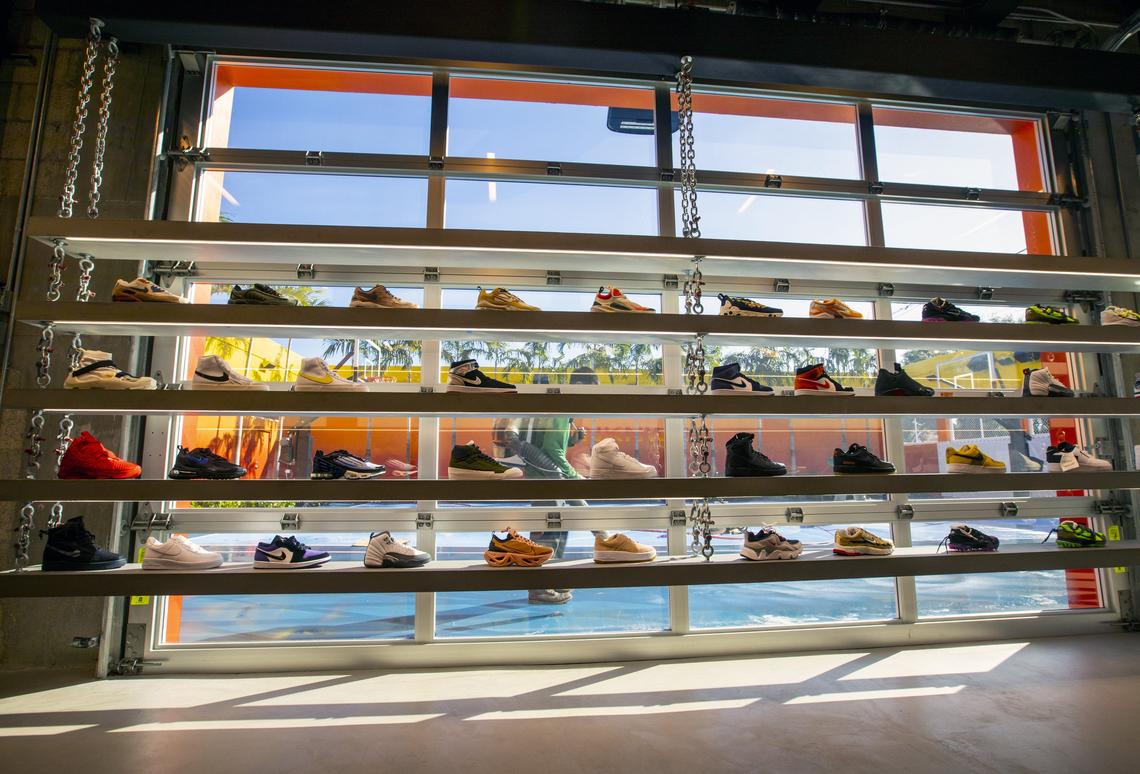A maintenance worker cleans the basketball court in the courtyard behind shelving stocked with shoes inside UNKNWN’s second storefront location before the store’s grand opening in Miami. The retail store, also co-owned by LeBron James, opened in Wynwood during Art Basel.