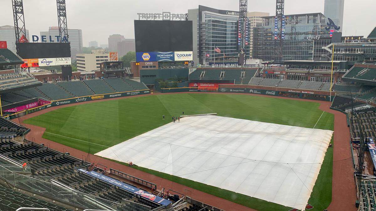 A tarp lies on the infield at Truist Park on Thursday, April 27, 2023.