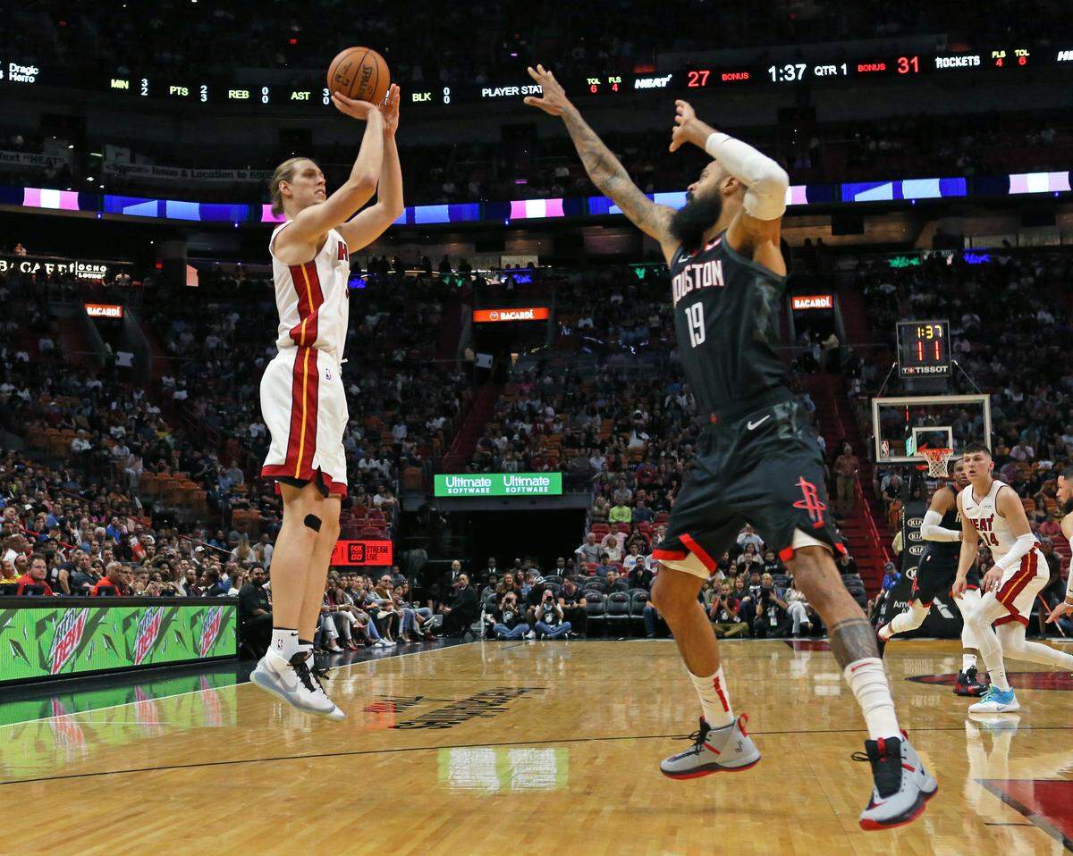 Heat center Kelly Olynyk (9) shoots over Rockets center Tyson Chandler (19) in the first quarter of an NBA basketball preseason game at the AmericanAirlines Arena on Oct. 18, 2019.