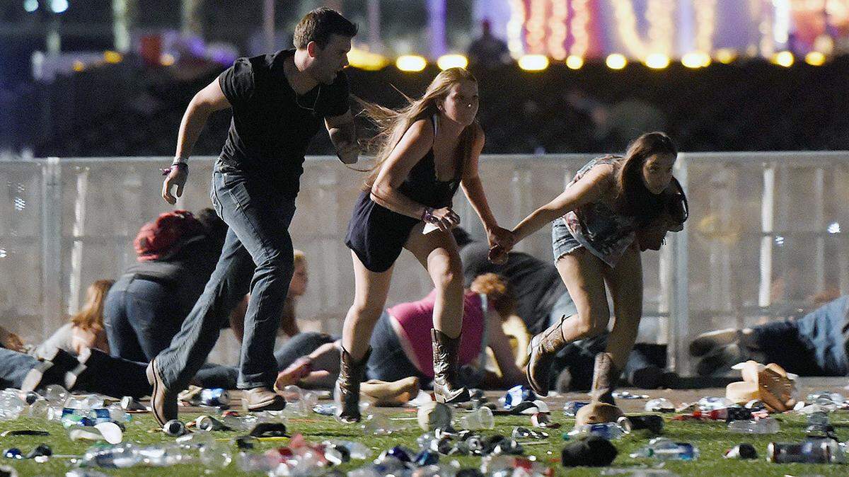 People run from a country music festival in Las Vegas, Nevada, in 2017 after hearing gunfire.