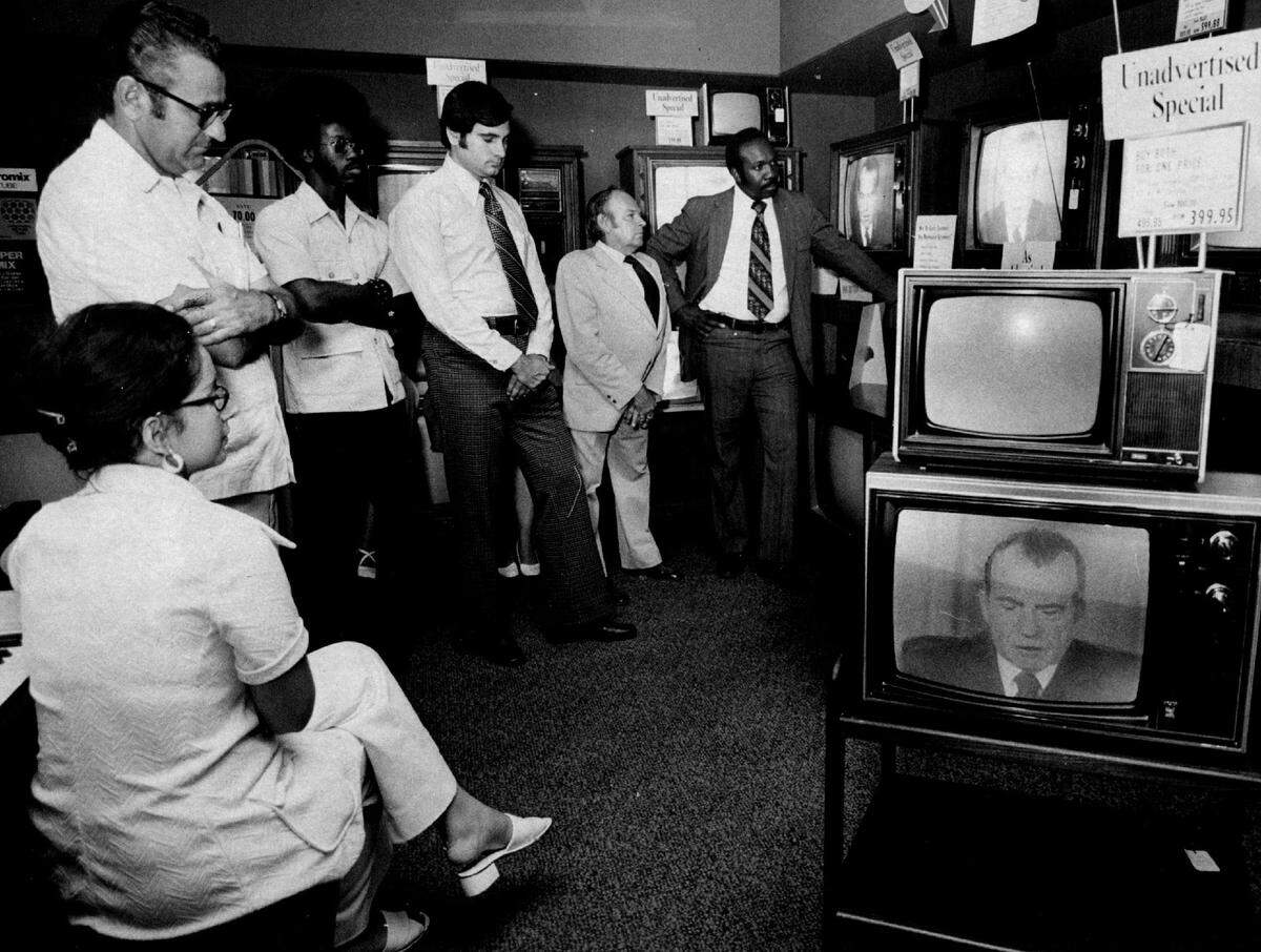 People watch the Nixon resignation in 1974 at a Miami Sears store.