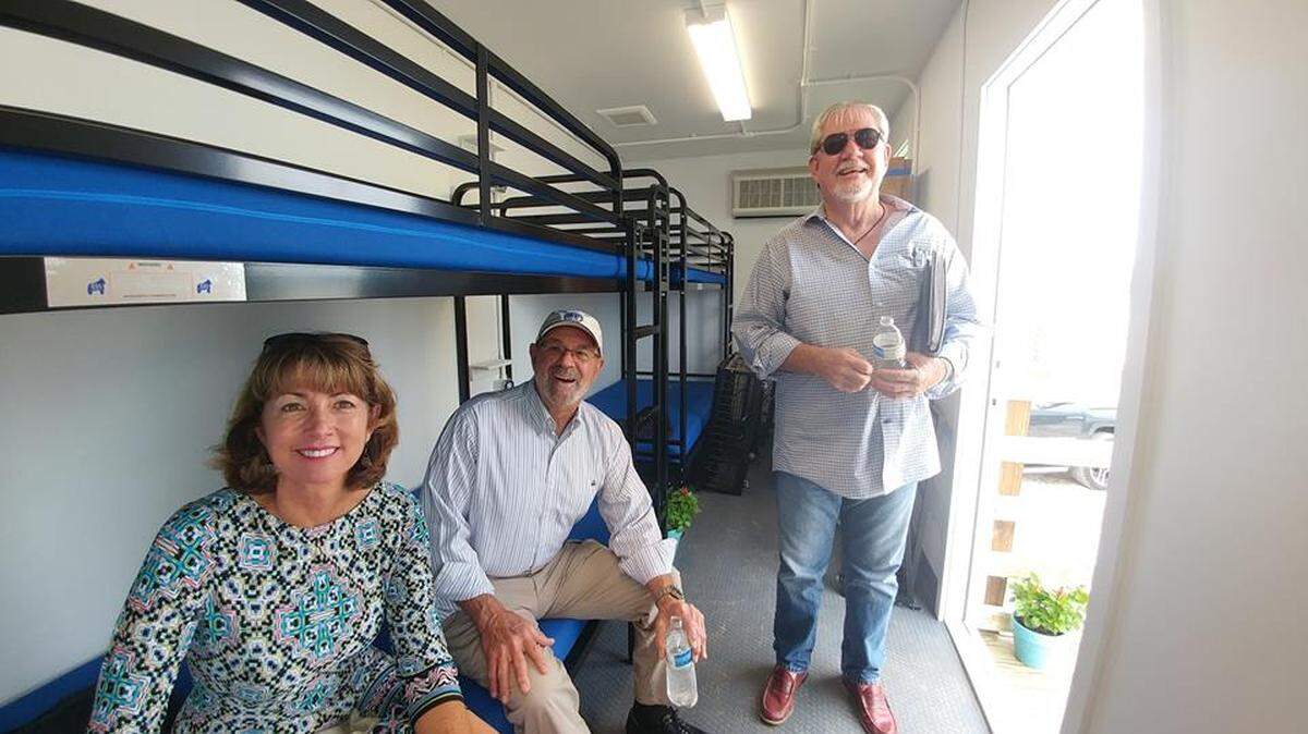 Monroe County Commissioners Michelle Coldiron and David Rice and former county commissioner George Neugent on March 5, 2019, try out the temporary sleeping quarters built for volunteers at “Volunteer Village” on Big Pine Key.