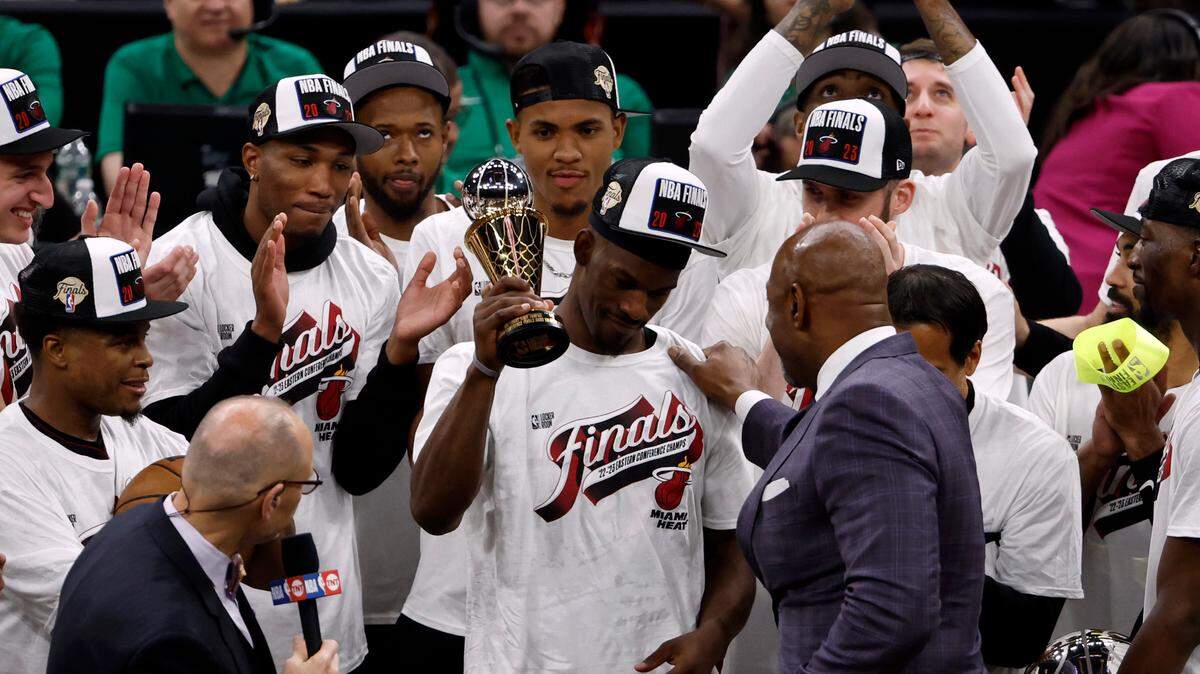 Miami Heat forward Jimmy Butler (22) celebrates with the MVP trophy after the Heat defeated the Boston Celtics in game seven of the Eastern Conference Finals for the 2023 NBA playoffs at TD Garden.