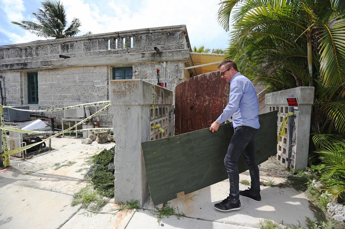 Red Fish Grill manager Chris Klaic removes a board to enter his shuttered restaurant on July 31, 2018, nearly one year after Hurricane Irma. The hurricane caused major damage to Klaic’s popular waterfront restaurant that sits within Matheson Hammock Park at 9610 Old Cutler Rd. in Coral Gables. The restaurant has been closed since the storm and is undergoing complete renovations. Klaic plans to be open for business by November 2018.