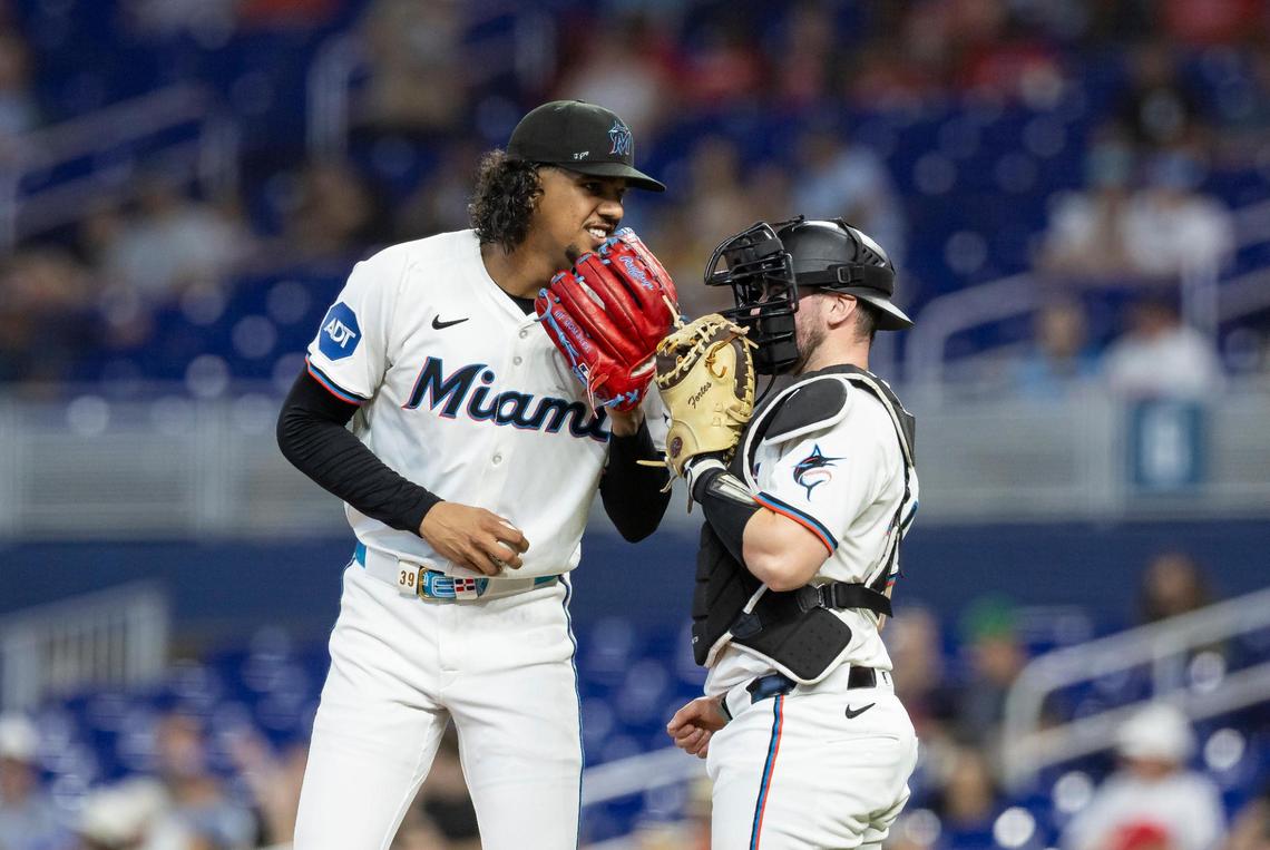 Miami Marlins starting pitcher Eury Perez (39) talks with catcher Liam Hicks (34) on the mound as they play against the Minnesota Twins in the third inning of their MLB game at loanDepot park on Thursday, July 3, 2025, in Miami, Fla.
