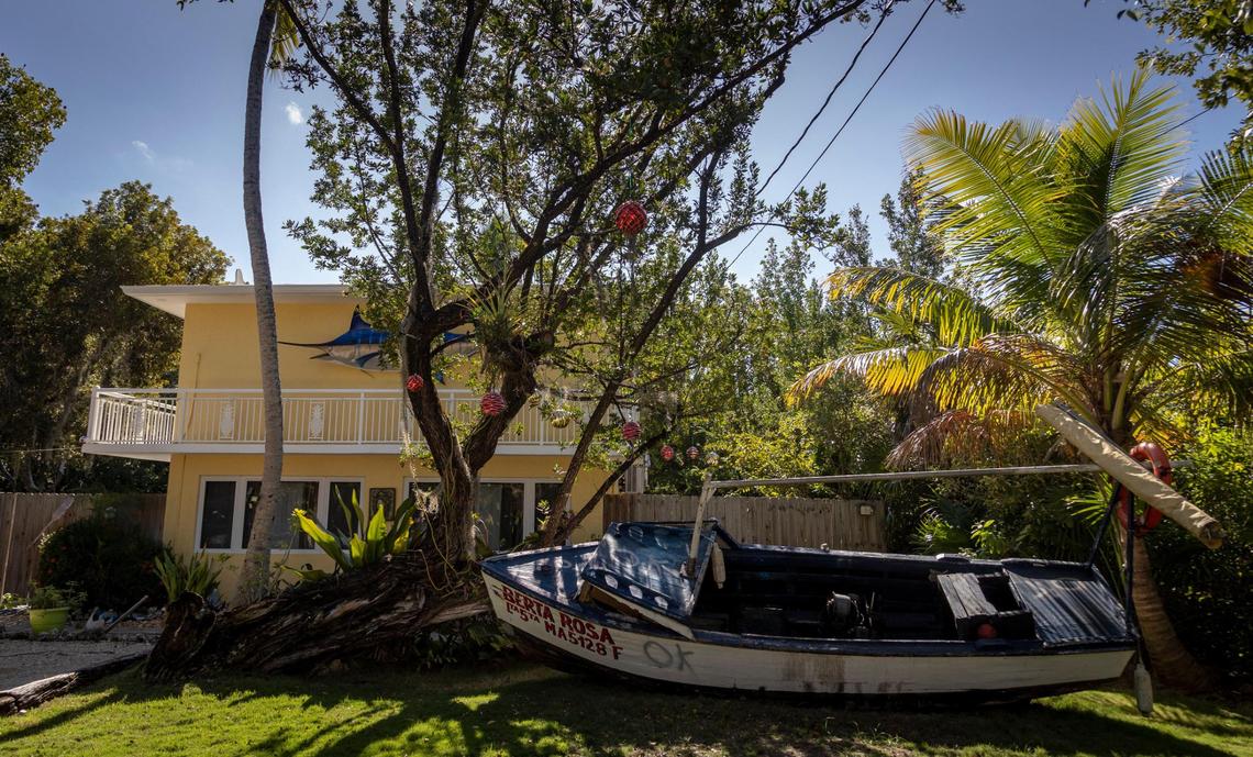 A boat used by Cuban migrants sits in front of residence in Key Largo on Jan. 8, 2023. Some of these vessels wind up being used as front lawn decorations by residents of the Florida Keys.