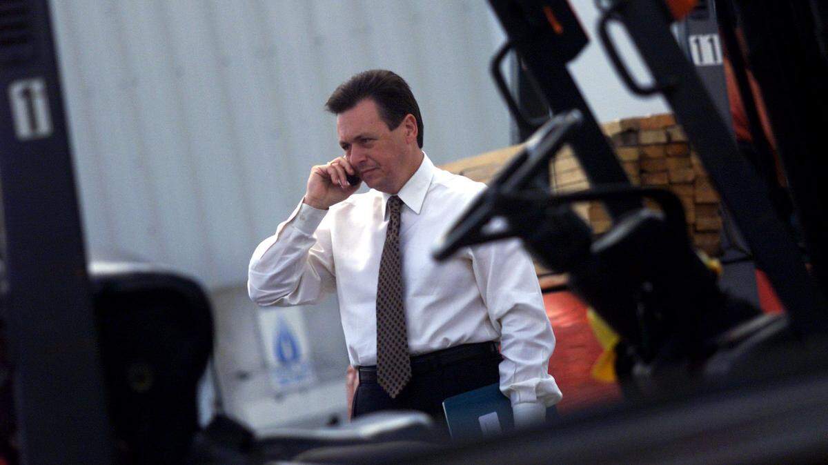 Influential businessman Sergio Pino, head of a publicly held building empire, talks on his cell phone as he walks through the lumber yard at Everglades Lumber, one of Century’s subdivisions on Southwest Eighth Street, on April 18, 2000. Pino died Tuesday, July 16, 2024, at the age of 67.