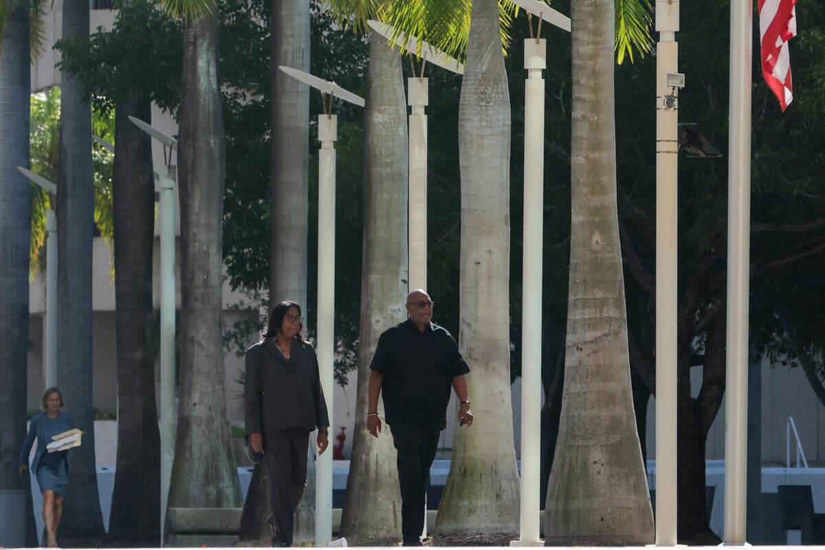 Charmaine Gatlin, the former chief operating officer of Jackson Health Foundation, arrives with her defense attorney David Howard, right, for a plea hearing at the Wilkie D. Ferguson Jr. U.S. Courthouse in Miami, Florida, Thursday, September 11, 2025.