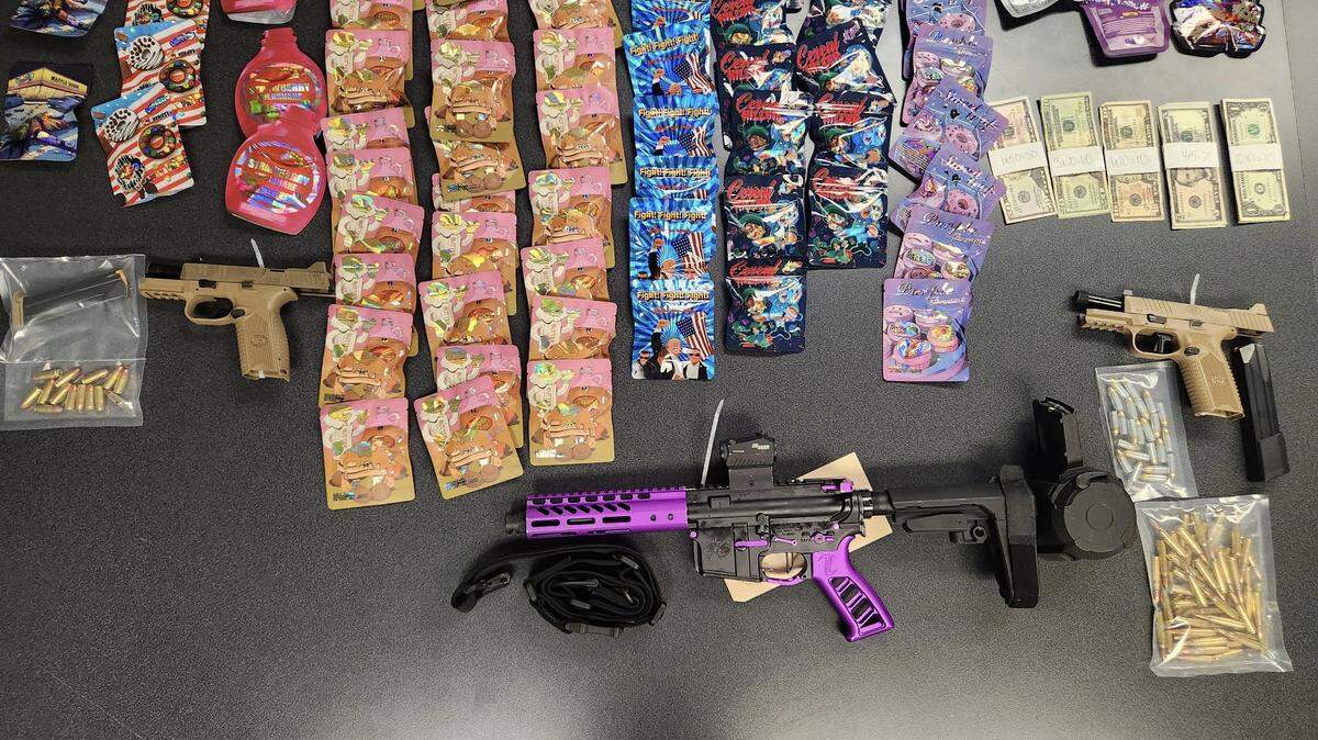 A semi-automatic rifle, two pistols, cash and marijuana packets are displayed by the Miami-Dade Sheriff’s Office. The evidence was taken Monday, Feb. 3, 2025, following a chase on the Palmetto Expressway in which a man in one car pointed a rifle at another vehicle in an attempt to get the driver to pull over, according to the sheriff’s office.