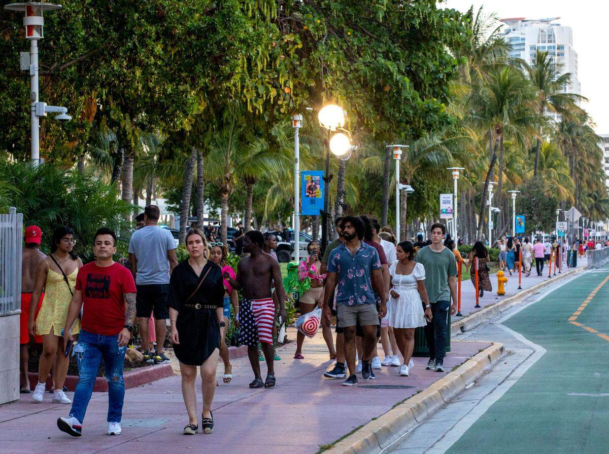 People walk Ocean Drive during the first day of Memorial Day Weekend in Miami Beach, Florida, on Friday, May 27, 2022.