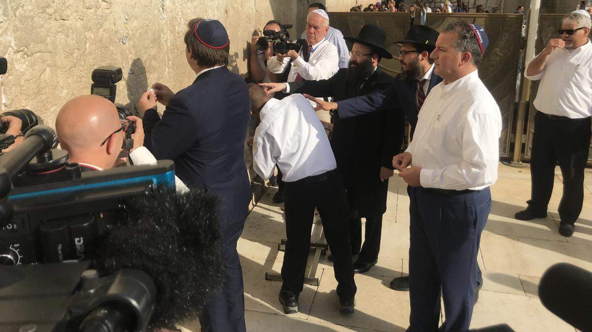 Gov. Ron DeSantis inserting a prayer for a safe Florida hurricane season in the Wailing Wall.