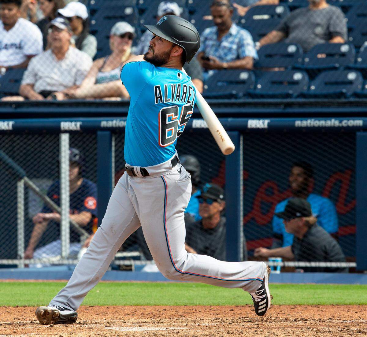 Miami Marlins infielder Eddy Alvarez (65) swings at a pitch during the seventh inning of a Spring Training game against the Houston Astros at FITTEAM Ballpark of the Palm Beaches in West Palm Beach, Florida on Tuesday, February 25, 2020.