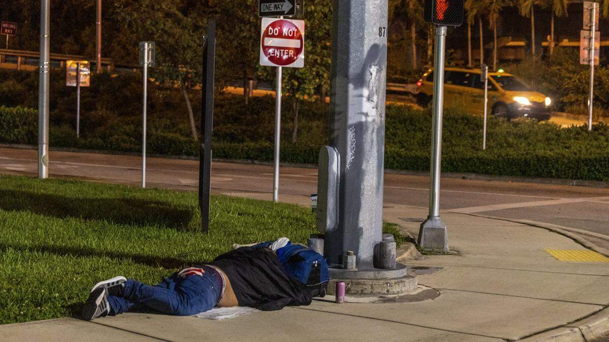 A homeless man sleeps on the sidewalk at NW 2nd Street in downtown Miami, during the Miami-Dade County's annual Point-in-Time (PIT) Homeless summer census of those experiencing homelessness from Homestead to Miami Beach to North Miami, conducted by members of the Miami-Dade Homeless Trust and the City of Miami Outreach Specialists, on Thursday, August 21, 2025.