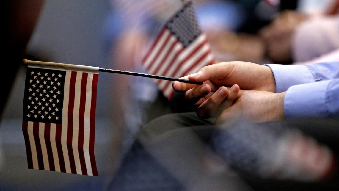 U.S. Citizenship and Immigration Services officials administer the Oath of Allegiance to 26 new U.S. citizens during a special naturalization ceremony at Everglades National Park, Ernest F. Coe Visitor Center, in Homestead on Wednesday, July 3, 2019. Twenty-six immigrants from 12 countries became naturalized citizens. The citizens originate from Cuba, El Salvador, Guatemala, Honduras, Peru and Venezuela.