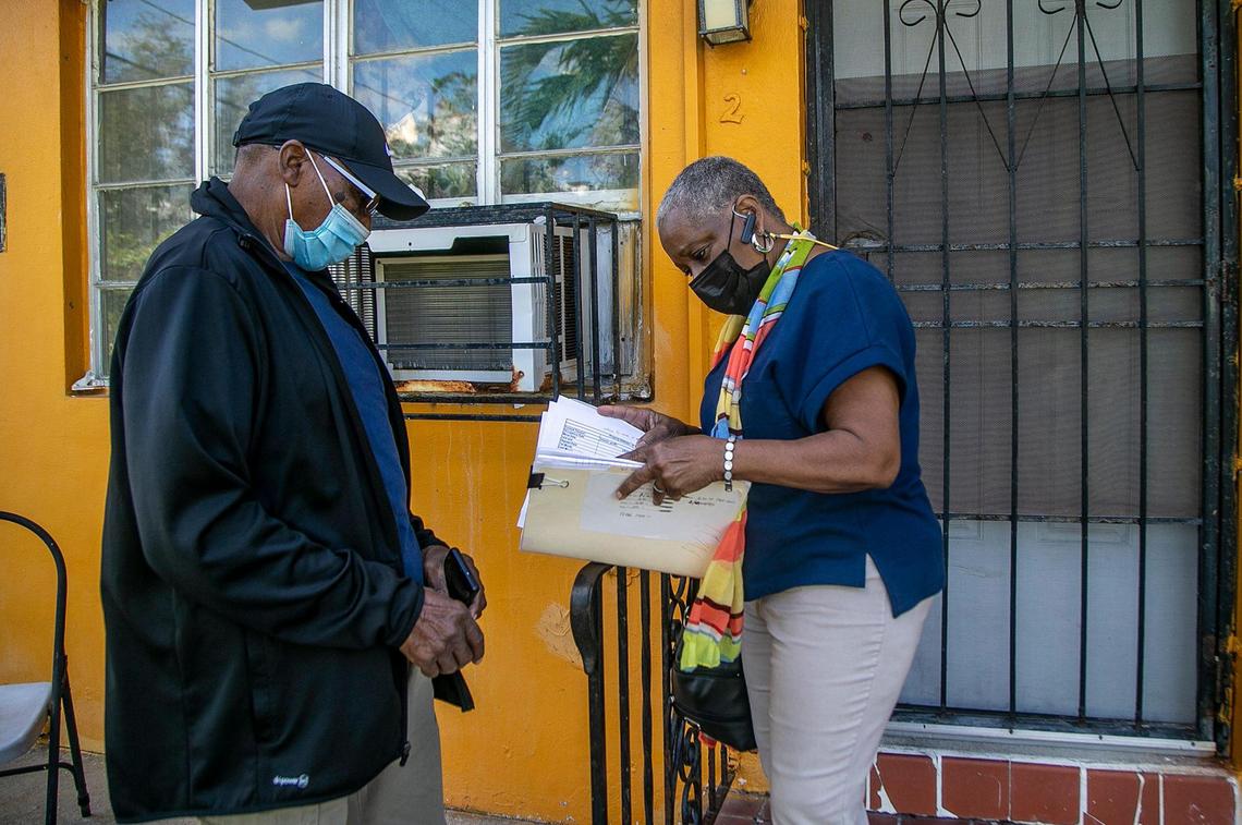 Linda Mallard and her father, John Palmer, look through eviction paperwork in front of an apartment in a building they own in the Little River neighborhood of Miami. They hired an eviction company to boot out the tenant living at that apartment, who stopped paying rent in February.