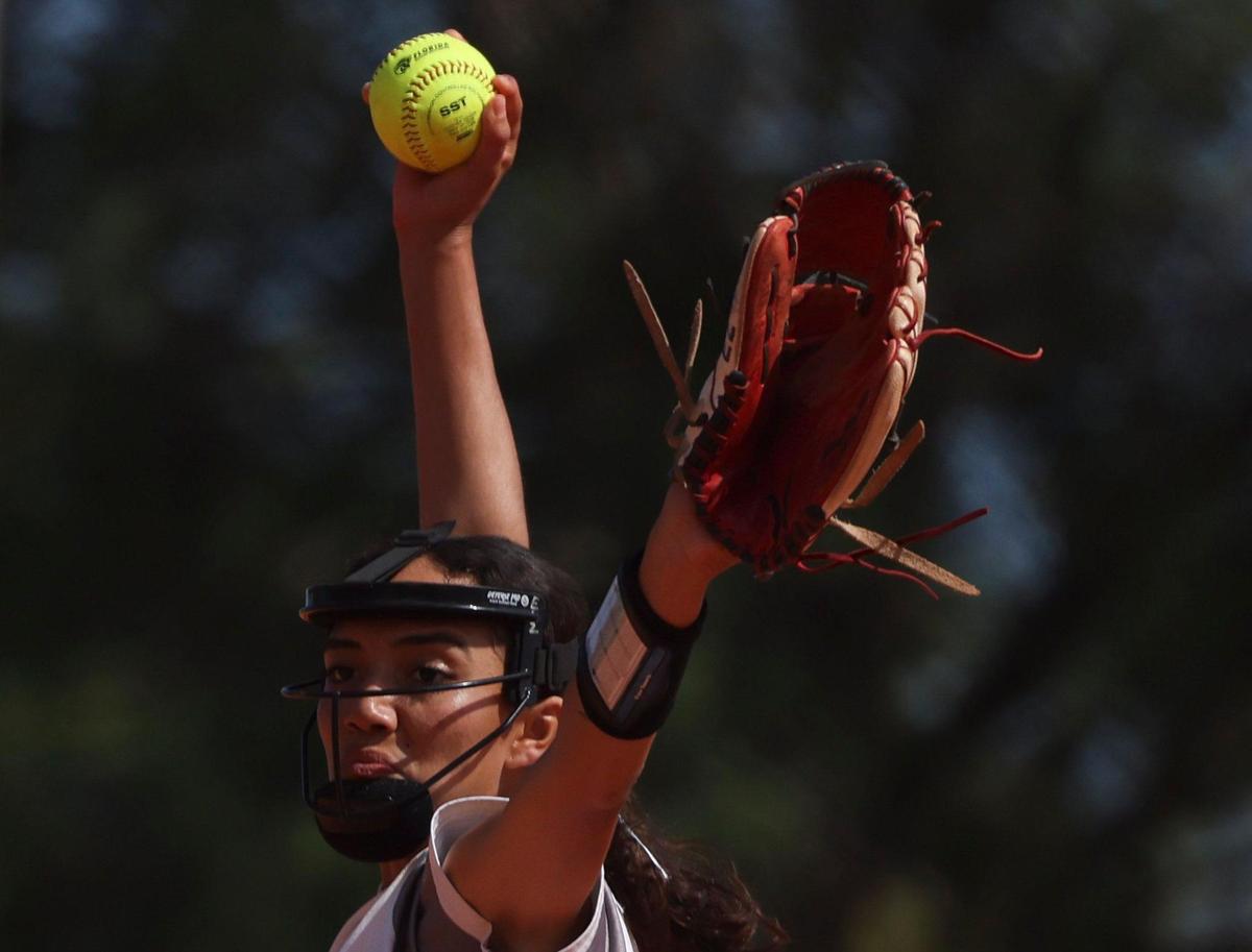 Coral Reef’s Erin Zambiano (8) itches the ball during the third inning of the Greater Miami Athletic Conference softball final on Thursday, April 20, 2023, at Coral Reef High School in Richmond Heights, Fla.