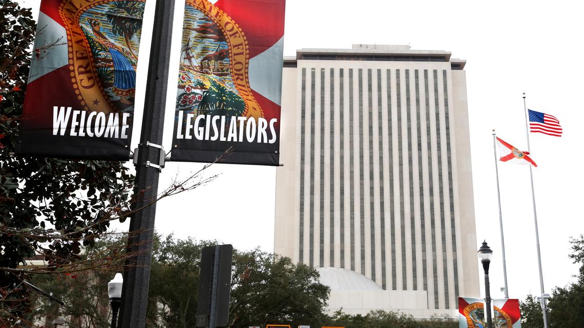 Banners greeting Florida lawmakers hang along Adams Street in Tallahassee with Florida's Capitol in the background before the start of the annual legislative session in January 2018.