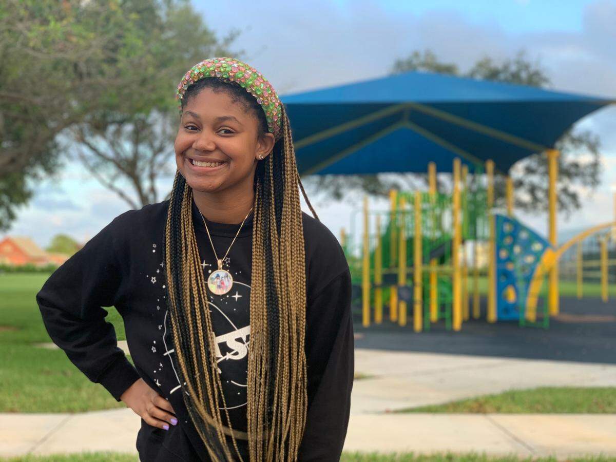 Ka’Mora McKenzie stands in front of a playground in Miami Gardens, Fla., Tuesday, November 17, 2020. McKenzie lost her mother in September but manages to keep it together for the sake of her two younger siblings.