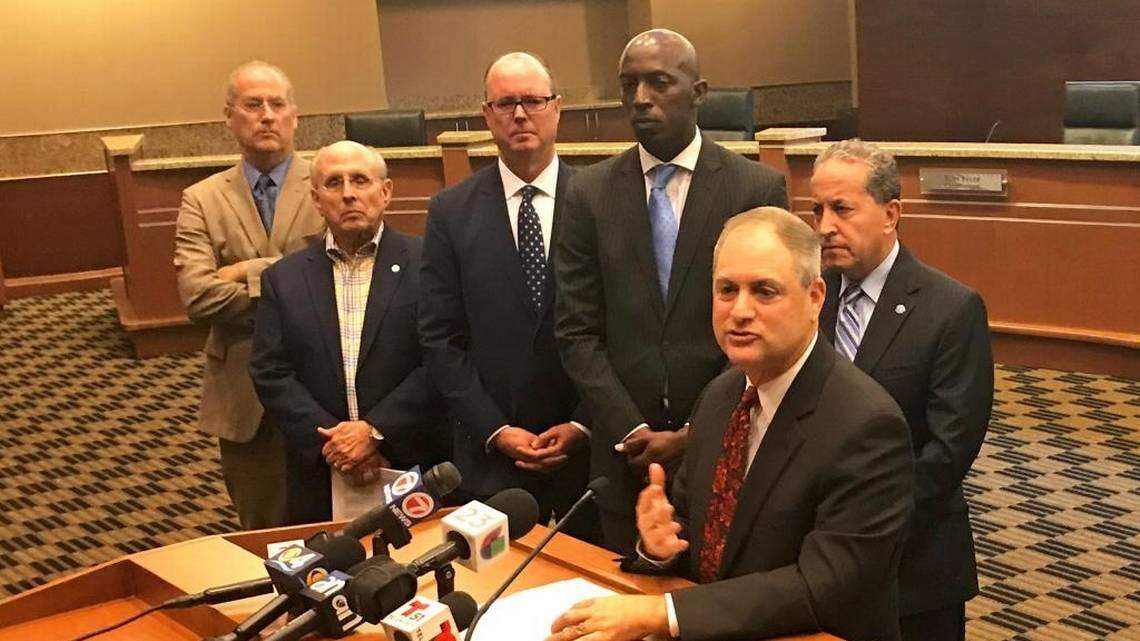 Jamie Cole, city attorney for Weston, addresses reporters during a City Hall press conference on Monday, April 2, 2018, about a lawsuit filed by 10 South Florida cities against Gov. Rick Scott and other state officials over a 2011 state law that established stiff penalties for enacting municipal gun regulations. Waiting their turns to speak, from left to right, are five named plaintiffs in the litigation: Miami Beach Mayor Dan Gelber, Coral Gables Mayor Raúl Valdés-Fauli, Pompano Beach Mayor Lamar Fisher, Miramar Mayor Wayne Messam and Weston Mayor Daniel Stermer.