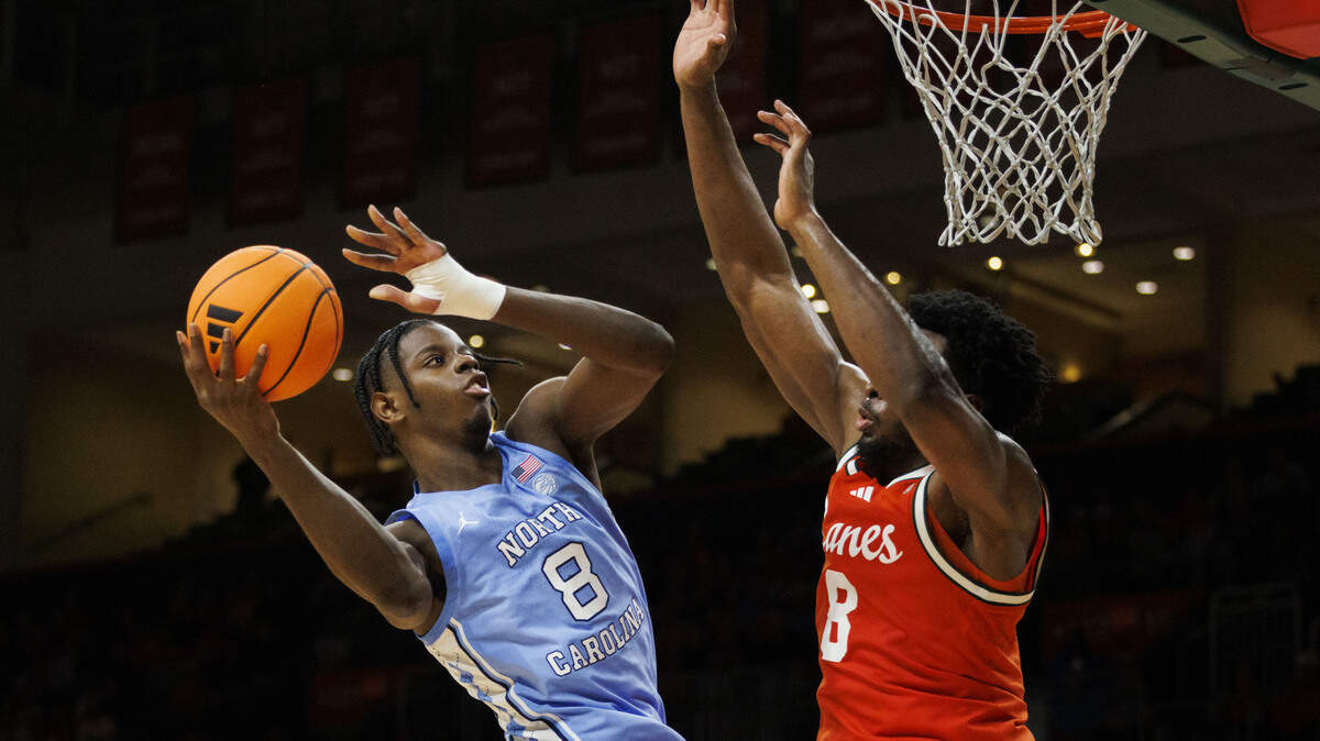 North Carolina Tar Heels forward Caleb Wilson (8) shoots the ball over Miami Hurricanes center Ernest Udeh Jr. (8) during the second half of a game on Tuesday, Feb. 10, 2026, at the Watsco Center in Coral Gables, Fla. The Miami Hurricanes won 75-66.