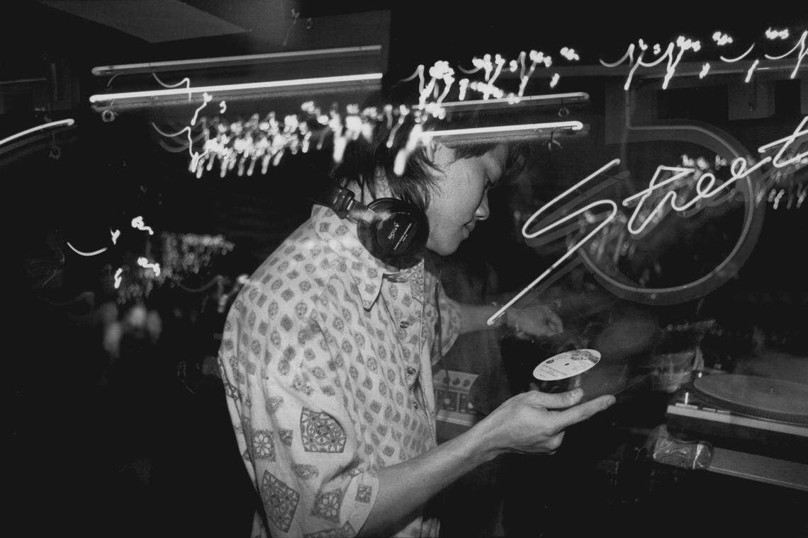 At 5th Street nightclub in Miami Beach in 1991, Waggy Tee, aka “Chinese Selecta,” spins the music.