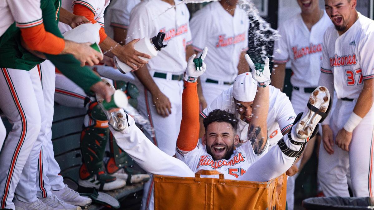 Miami outfielder Gaby Gutierrez (55) celebrates his homer with teammates throwing water in him during the third inning of a baseball game against LIU on Sunday, Feb. 25, 2024, at Alex Rodriguez Park in Coral Gables.