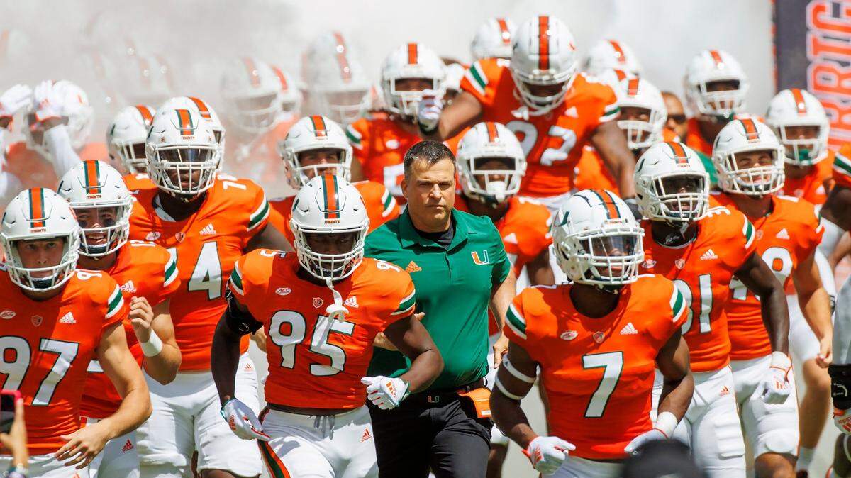 Miami Hurricanes head coach Mario Cristobal take the field with the team during the first quarter of an NCAA non conference game at Hard Rock Stadium on Saturday, September 10, 2022 in Miami Gardens, Florida.