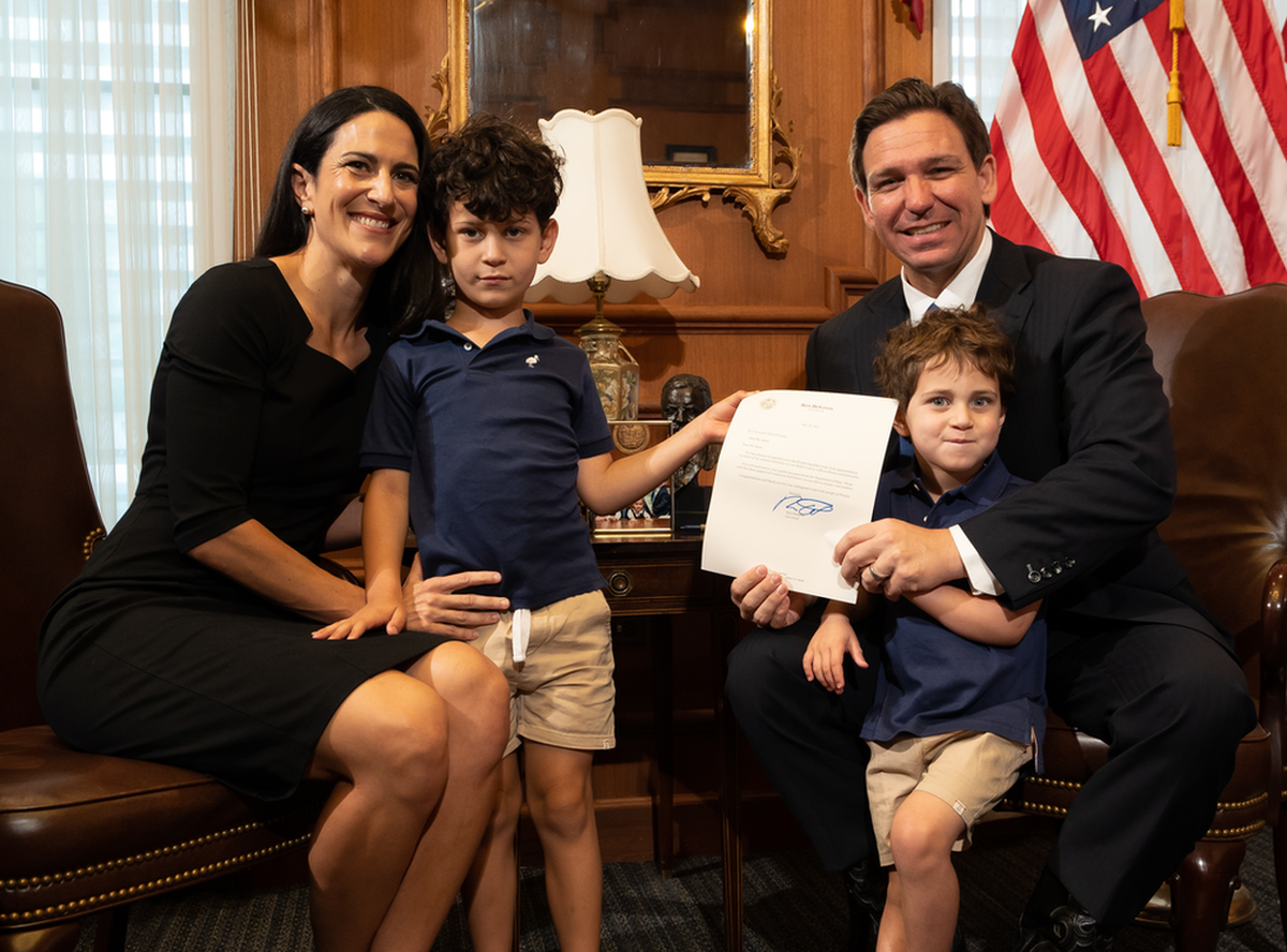 Gov. Ron DeSantis poses with newly appointed Florida Supreme Court Justice Meredith Sasso and her children in his office on Tuesday, May 23, 2023.