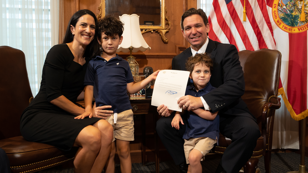 Gov. Ron DeSantis poses with newly appointed Florida Supreme Court Justice Meredith Sasso and her children in his office on Tuesday, May 23, 2023.