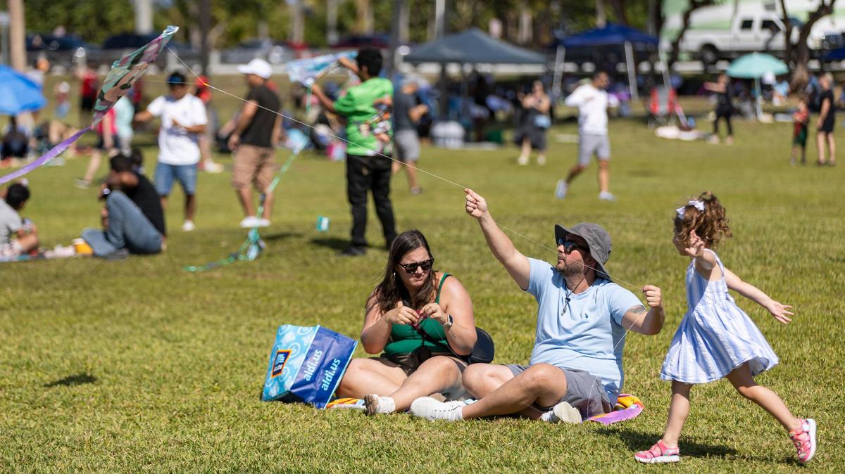 From left to right: Kriss Blanco, Jose Correia and Sabrina Correia-Blanco, 3, fly their kite during the 33rd Annual Kite Festival in Northeast Miami-Dade on Saturday, Feb. 15, 2025.