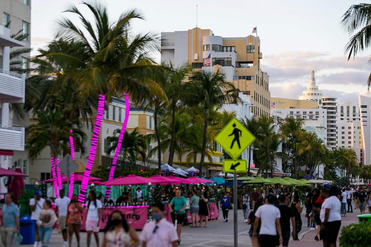 Tourists walk along Ocean Drive during spring break in Miami Beach on Monday, March 22, 2021.