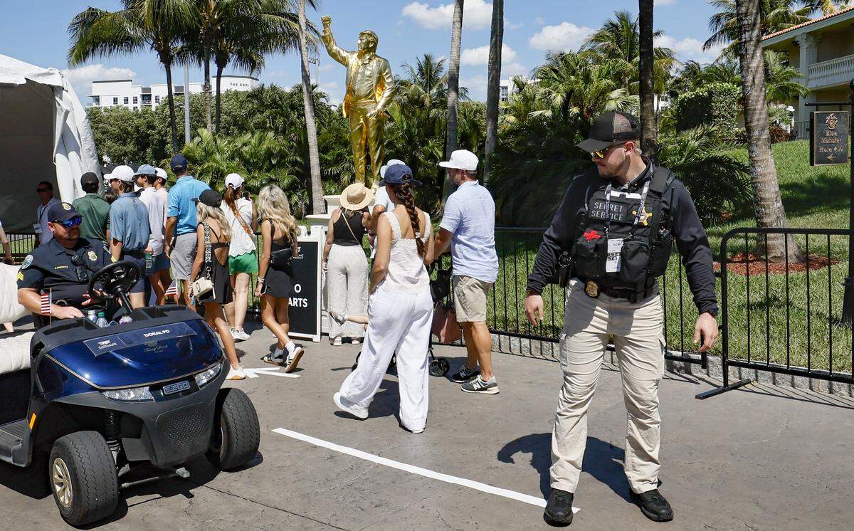 Los asistentes se acercan a una entrada de seguridad frente a la nueva estatua dorada del presidente Donald Trump durante la tercera ronda del Campeonato Cadillac 2026 en el Trump National Doral, en Doral, Florida, el sábado 2 de mayo de 2026.