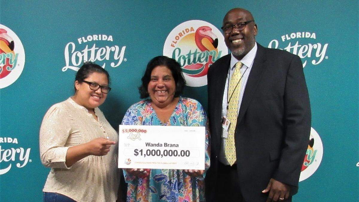Wanda Brana, center, with Florida Lottery officials at the Tallahassee headquarters. Brana won the $1 million prize in the $5,000,000 LUCK Scratch-Off game and on June 8, 2021, said she’d use her lump sum amount to buy a house.