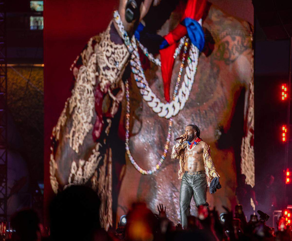 Burna Boy dons a Haitian flag as he performs at Afro Nation Miami at loanDepot Park on Saturday, May 27, 2023.