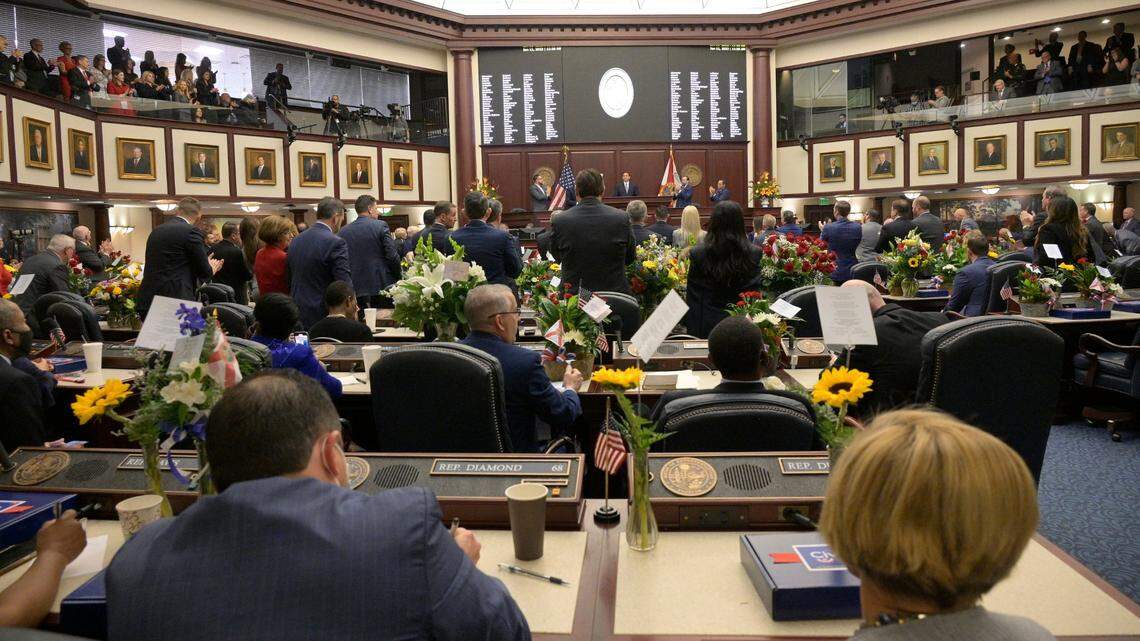 Democratic members remain sitting as Republicans stand and applaud while Florida Gov. Ron DeSantis addresses a joint session of the Legislature, Tuesday, Jan. 11, 2022, in Tallahassee, Fla. 