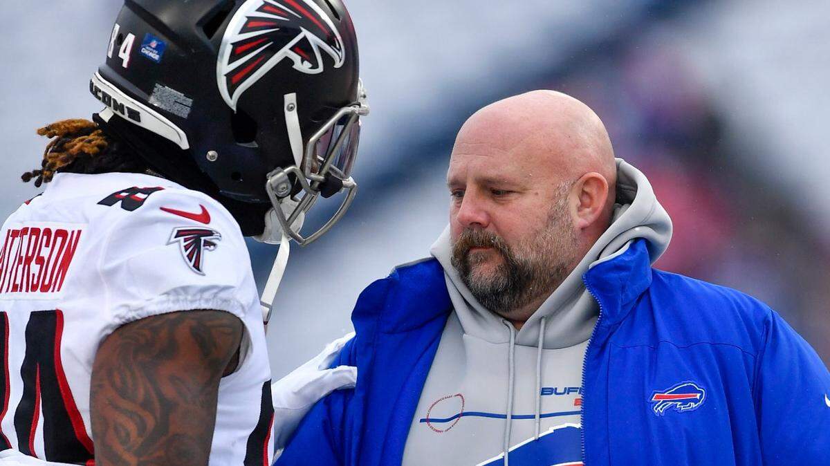 Atlanta Falcons running back Cordarrelle Patterson, left, greets Buffalo Bills offensive coordinator Brian Daboll before an NFL football game in Orchard Park, N.Y., Sunday, Jan. 2, 2022. (AP Photo/Adrian Kraus)